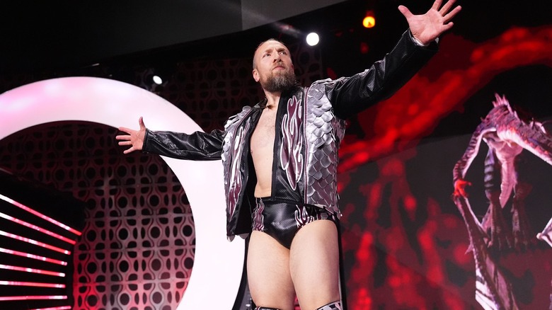 Bryan Danielson makes his entrance with his arms outstretched. 