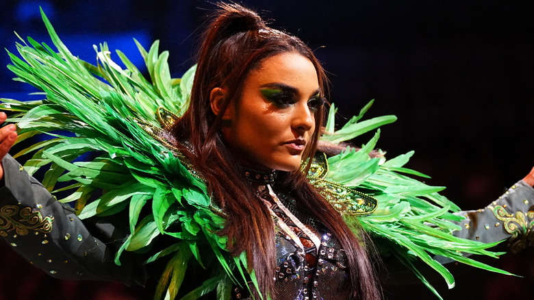 Deonna Purrazzo wearing a green, feathered jacket