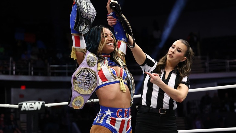 Mercedes Mone holding up all her titles on "AEW Dynamite."