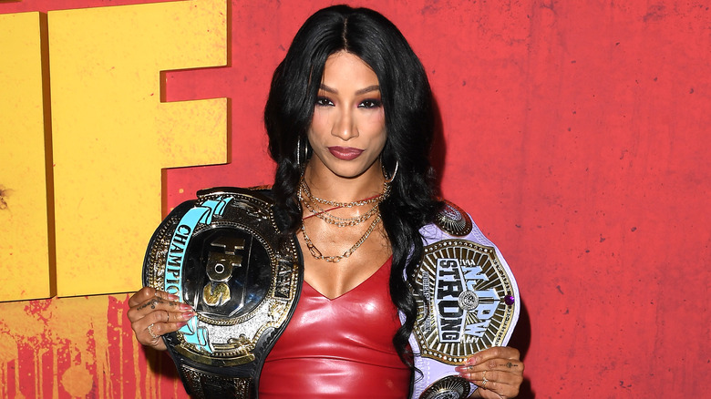 Mercedes Mone on the red carpet with both the TBS and New Japan Strong Women's Championships