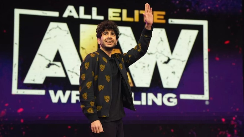 AEW President Tony Khan waves to the crowd during an AEW event