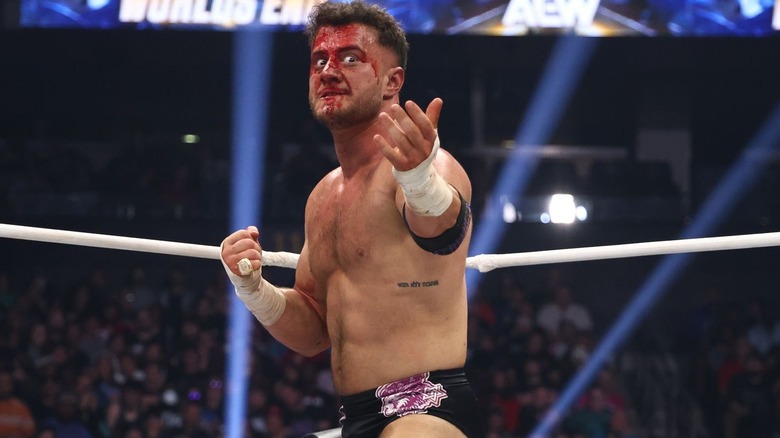 A bloody MJF makes a dramatic gesture in the ring at AEW Worlds End