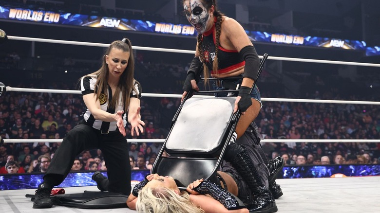 Thunder Rosa tries to choke out Mariah May with a chair as referee Aubrey Edwards tries to intervene at AEW Worlds End