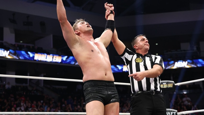 Referee raising Kazuchika Okada's arm at AEW Worlds End