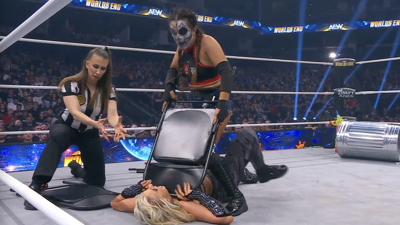 Rosa using a chair to target May's throat