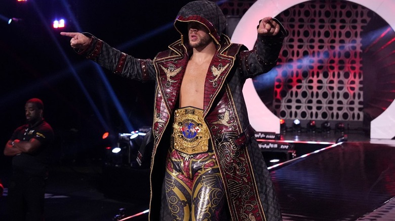 Will Ospreay wearing hooded coat and title belt