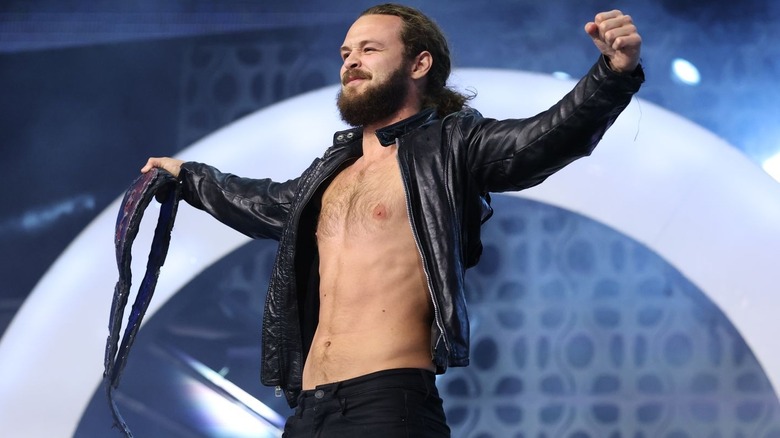 Jack Perry with arms wide holding the TNT title