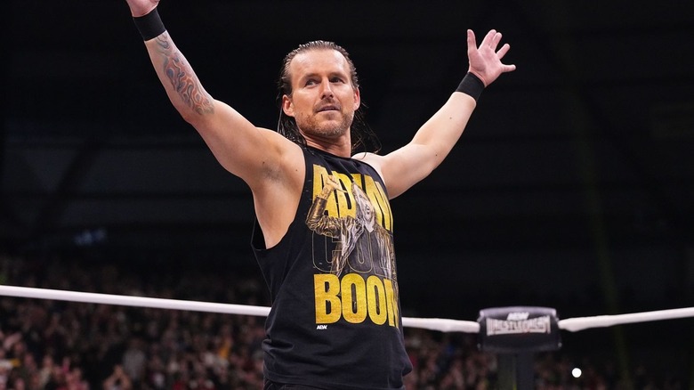 Adam Cole raises his arms