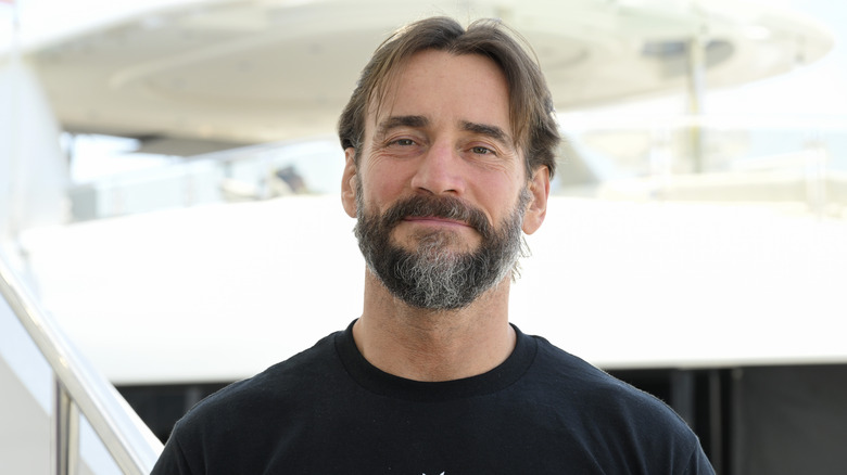 CM Punk poses backstage at an event