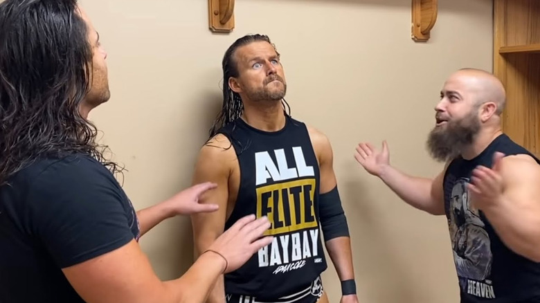 Alex Reynolds and John Silver confer with Adam Cole on "Being the Elite"