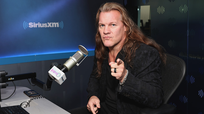 Chris Jericho posing at a radio microphone