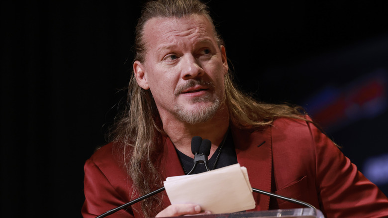 Chris Jericho wearing a red suit jacket