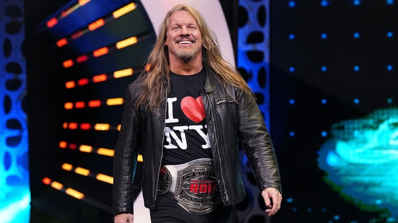 Chris Jericho smiling and wearing ROH World Championship