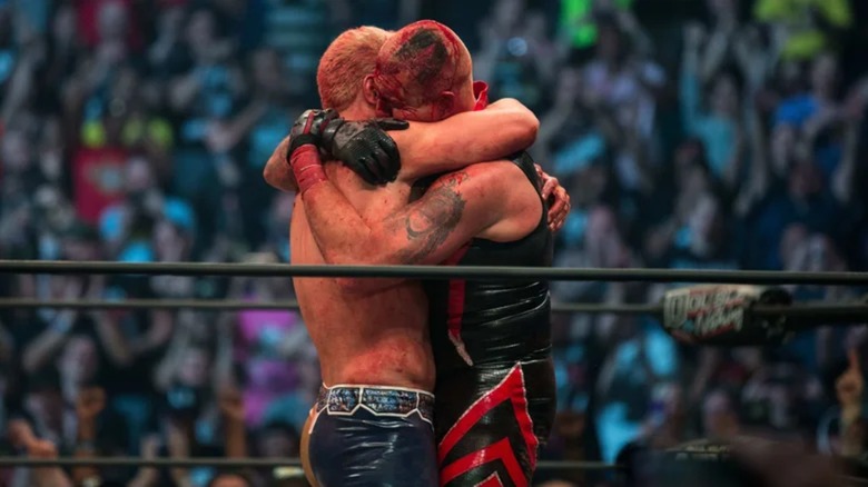 Cody Rhodes and Dustin Rhodes embracing after their brutal match at AEW Double or Nothing, 2019