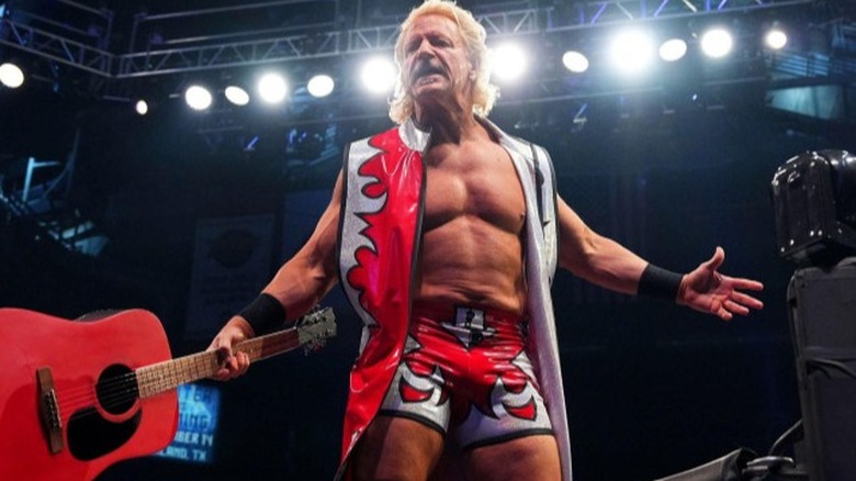 Jeff Jarrett, with iconic acoustic guitar in hand, looks out to the fans after a match on AEW