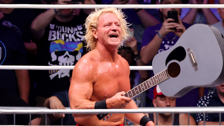 Jeff Jarrett holds out his guitar