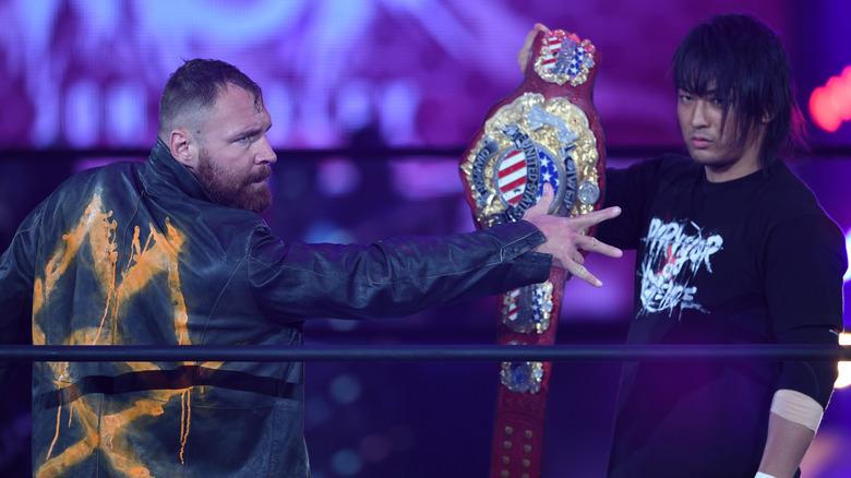 Jon Moxley and Shota Umino share a moment with the IWGP United States Heavyweight Championship