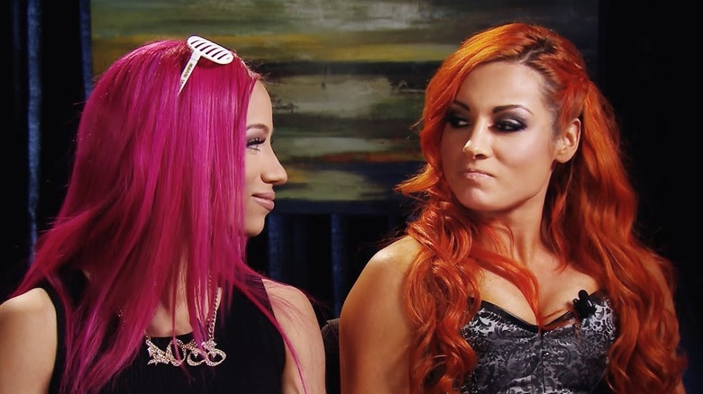 WWE's Sasha Banks gives a smile to Becky Lynch during a sit-down interview