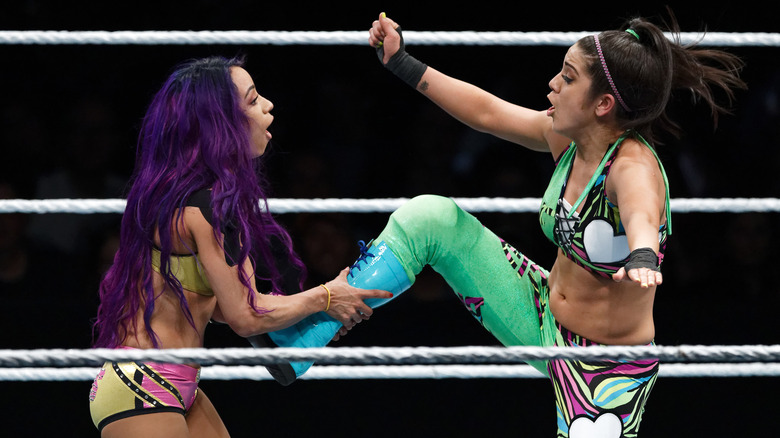 Sasha Banks grabs Bayley's foot