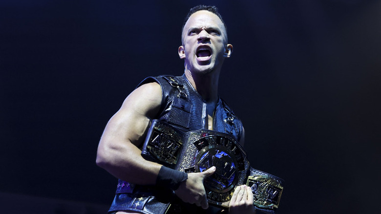 Ricky Starkz holding one-half of the AEW World Tag Team Championship