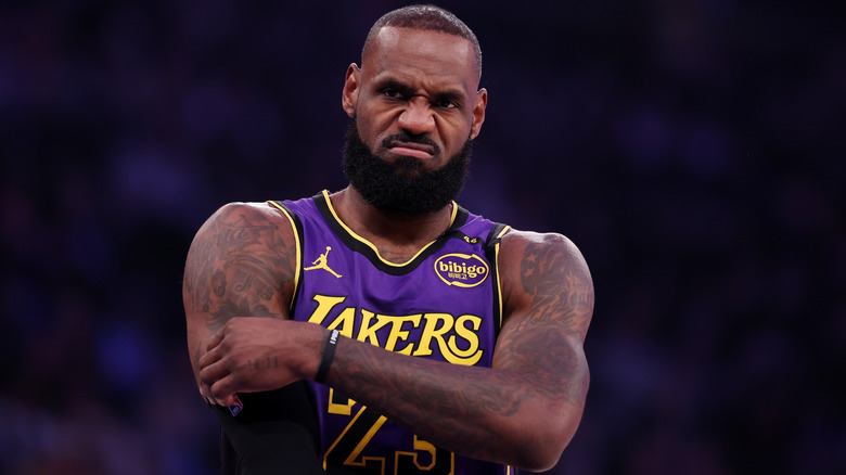 LeBron James scowls, with his arms folded