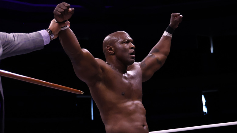 Shelton Benjamin with his hands held high in the ring