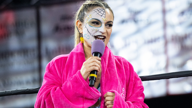 Thunder Rosa holding a microphone