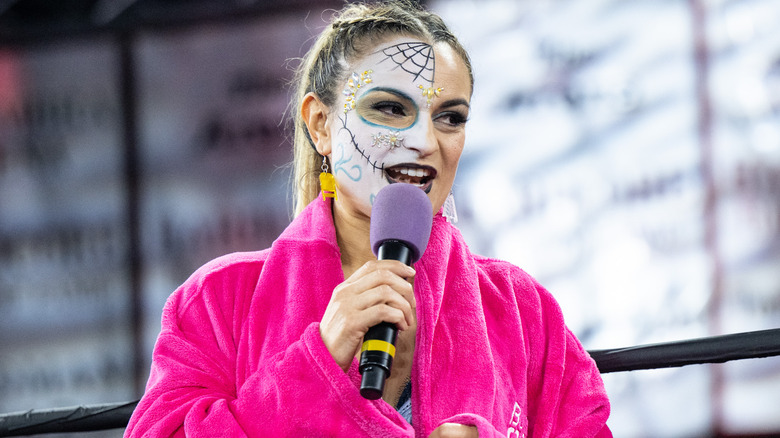 Thunder Rosa speaking into a microphone
