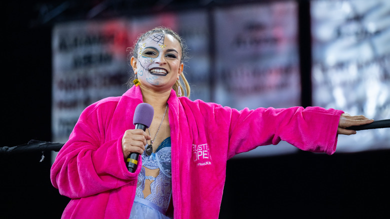 Thunder Rosa holding a microphone at an event