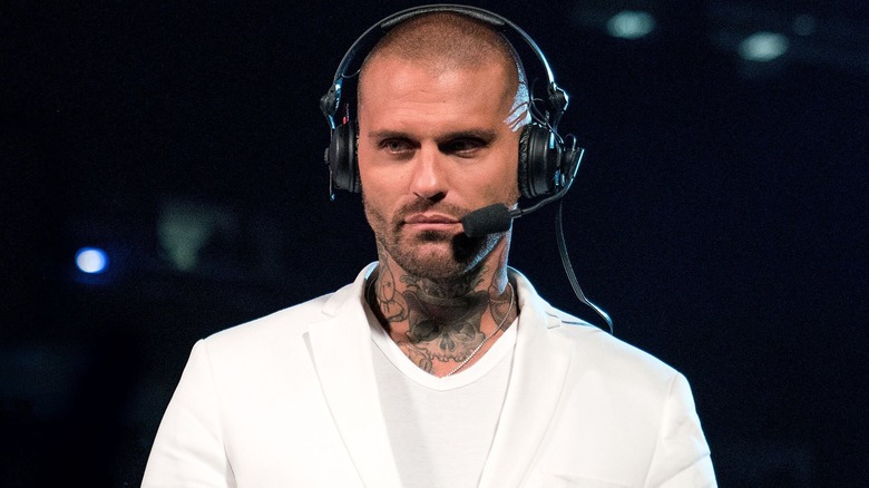 Corey Graves wearing a white jacket and shirt