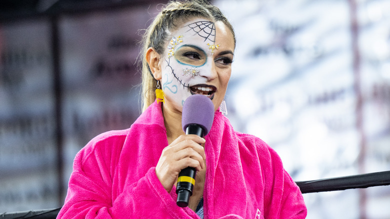 Thunder Rosa holding a microphone