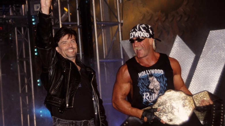 Eric Bischoff and Hulk Hogan making their way to the ring during a WCW show.