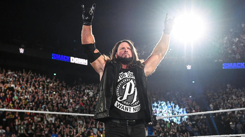 AJ Styles holds up his arms