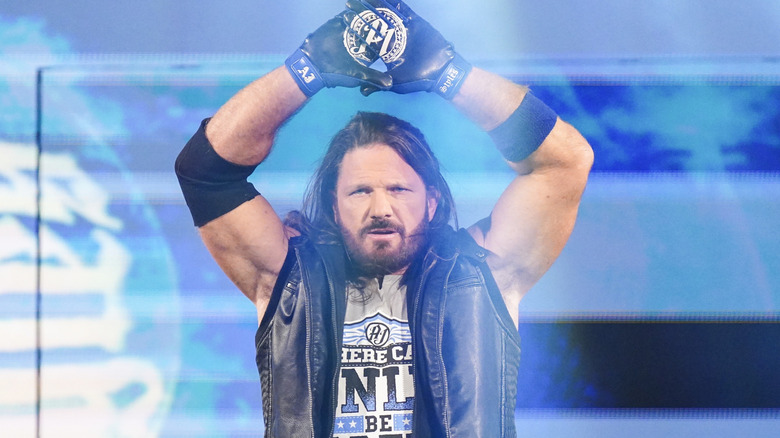 AJ Styles holds up his hands