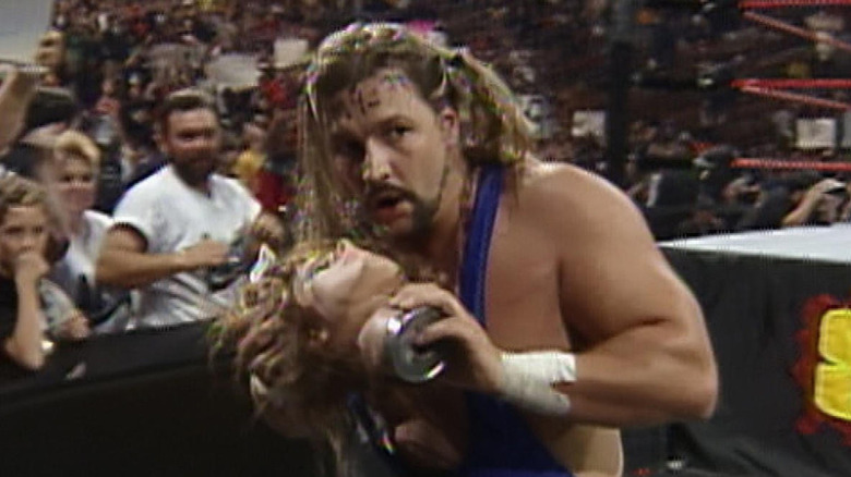 Al Snow carrying a mannequin head