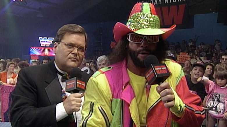 Jim Ross and Randy Savage hold mic