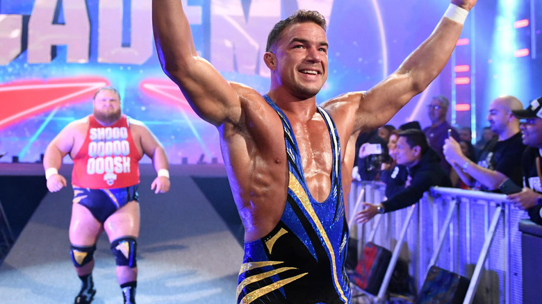 Chad Gable raises his arms with Otis behind him