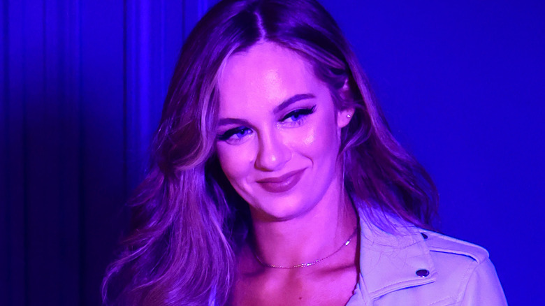 Anna Jay stands in blue lit room