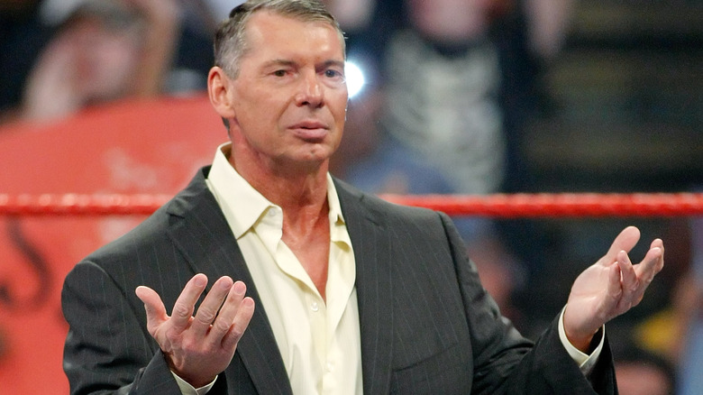 Vince McMahon with hands raised
