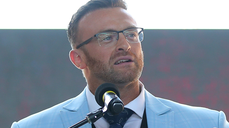 Nick Aldis wearing glasses