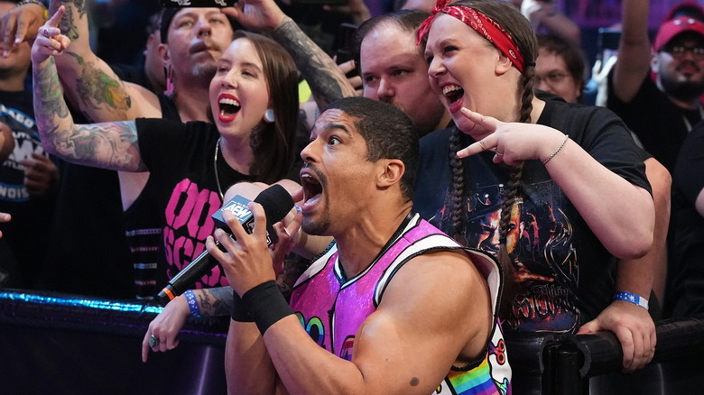 Anthony Bowens shouting into a microphone in front of AEW fans