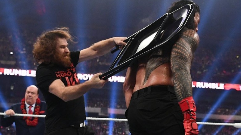 Sami Zayn hits Roman Reigns with chair