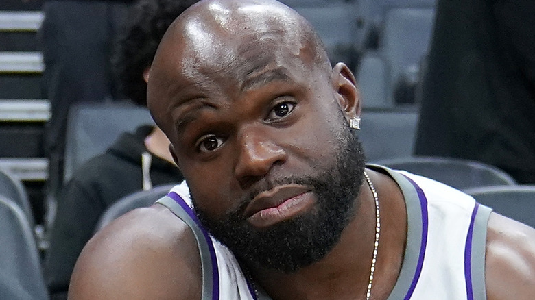 Apollo Crews sitting at an NBA game