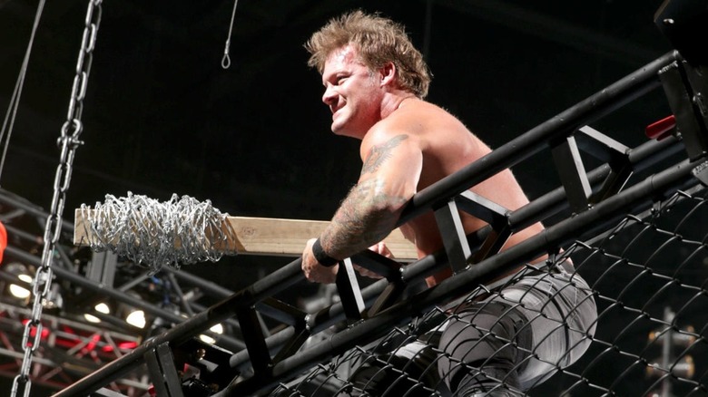 Chris Jericho holding a barbed wire 2x4
