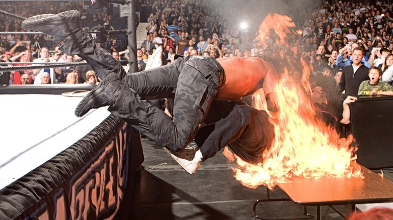 Edge spears Mick Foley through fire