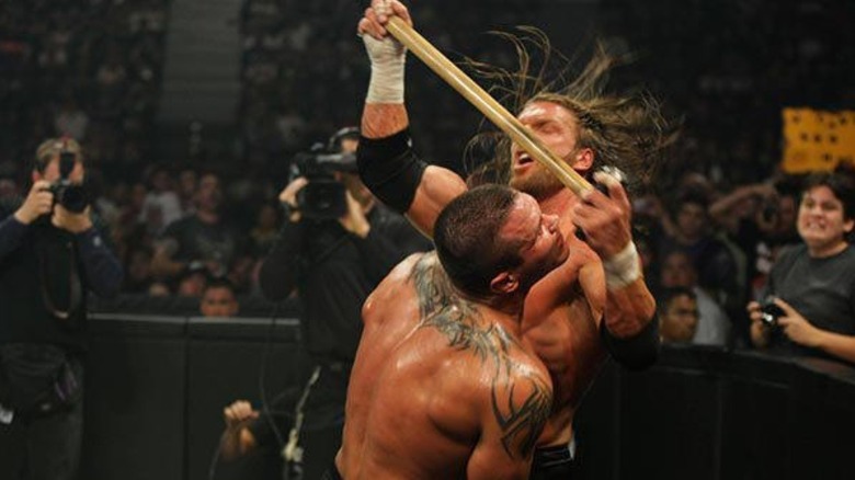 Triple H hits Randy Orton with a sledgehammer