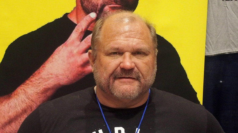 Arn Anderson stands in front of a photo of himself