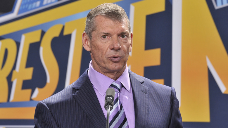 Vince McMahon stands at a podium