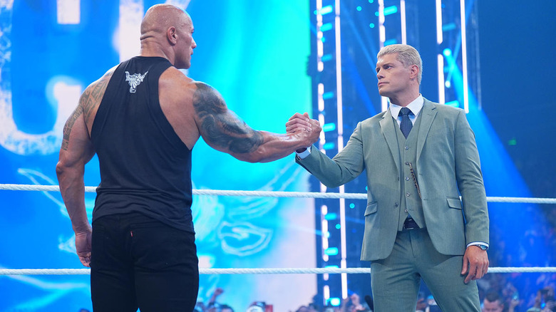 Cody Rhodes shakes hands with The Rock