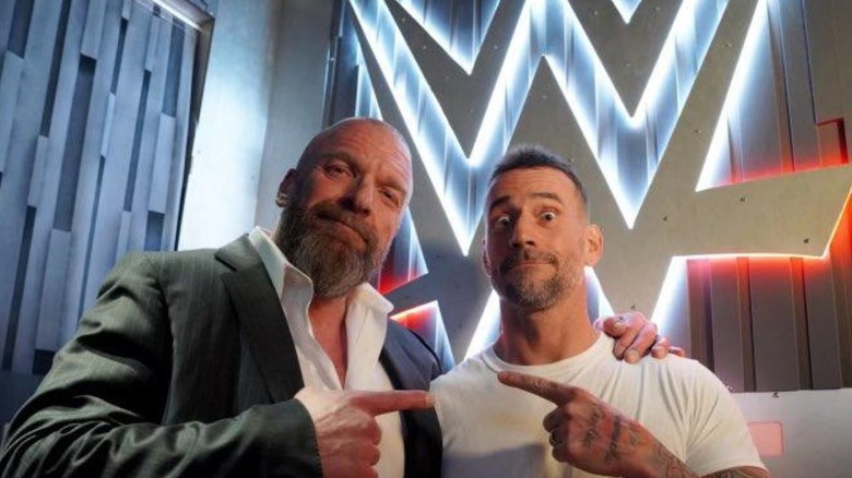CM Punk and Triple H posing